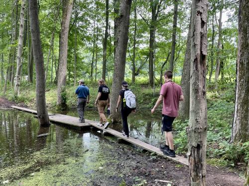 alking a trail are, from left, Jim D'Angelo, director of Sterling Nature Center, with student filmmakers Wells Liscomb and Lauren Smith (both seniors) and Ryan King (who graduated in 2023).