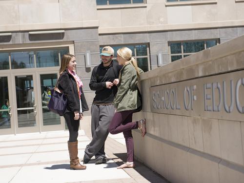 Students standing outside of the School of Education building