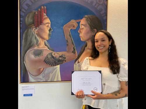 Sofia Luz Pérez stands next to her award winning painting 