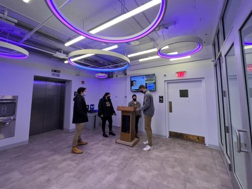 Admissions interns check in visitors for a program in The Space