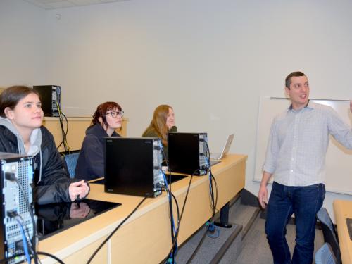 Faculty member Mark Baker speaks with students in a statistics class