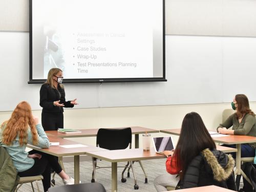 Michelle Storie of the counseling and psychological services faculty teaches a class in Wilber Hall