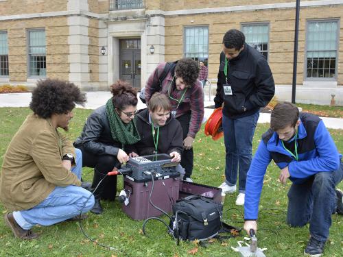 Students unpack a seismograph system