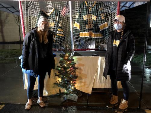 Laker women's hockey players help collect stuffed animals for the drive-through Teddy Bear Toss