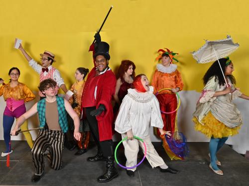 Performers in circus attire pose in a production image for Tuck Everlasting