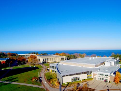 Aerial view of campus with fall foliage and Lake Ontario