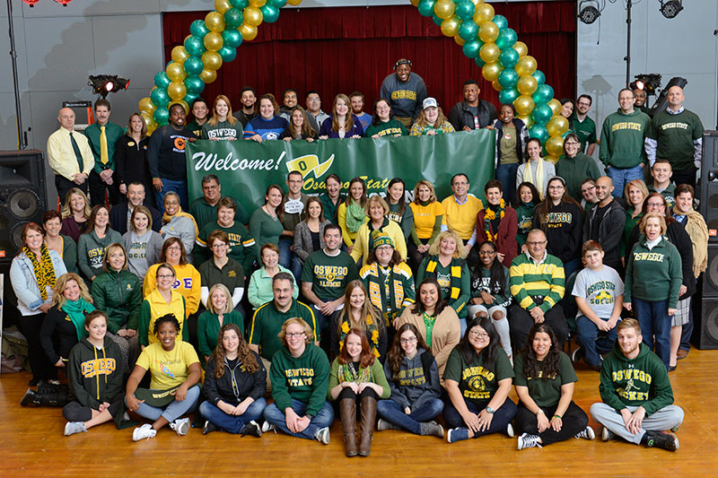 Campus community members in green and gold