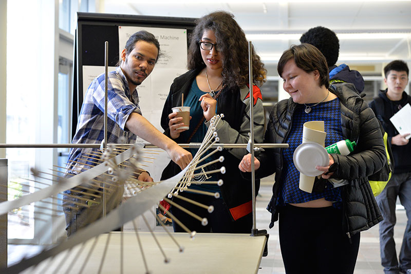 Students showing physics demonstration