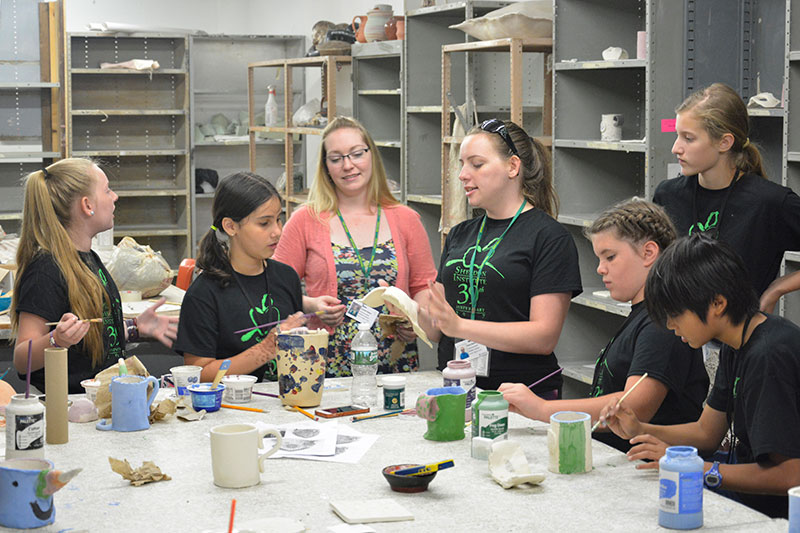 Faculty work with students at Sheldon Institute