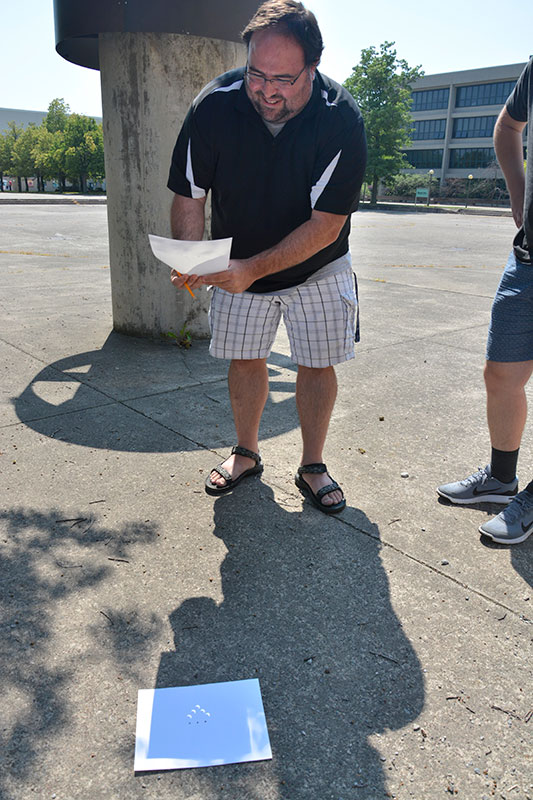 Dan Laird views eclipse through pinhole camera