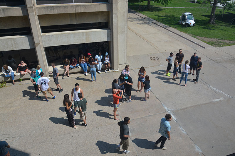 Students and staff watching eclipse