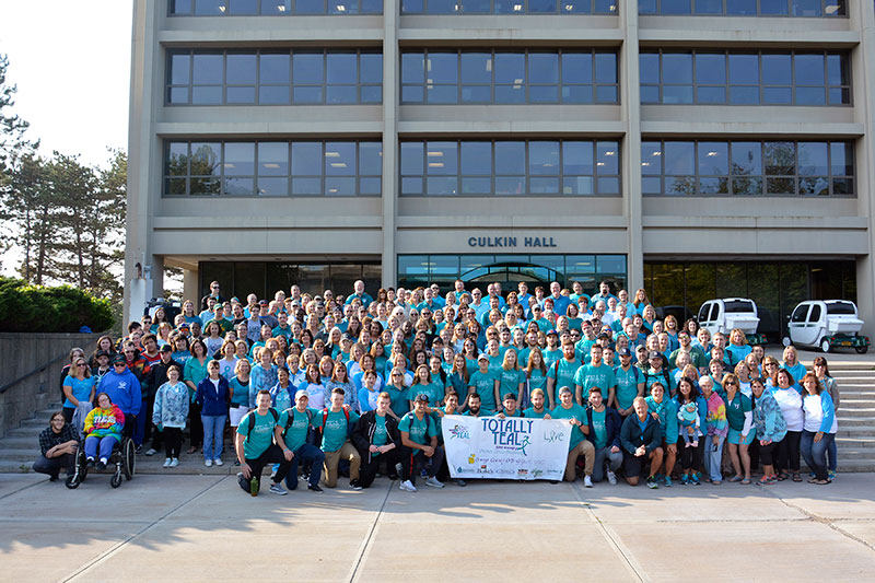 Campus community takes group photo in teal