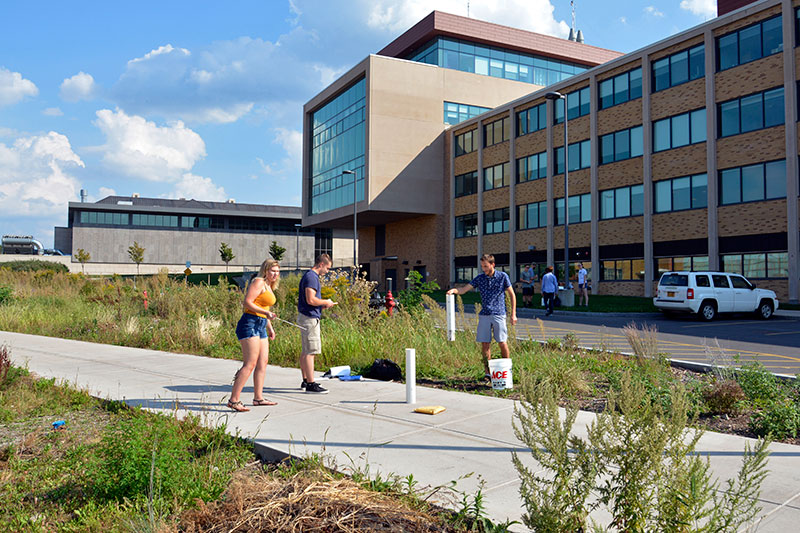 Hydrogeology class takes part in water-infiltration study at SUNY Oswego’s Permaculture Living Lab