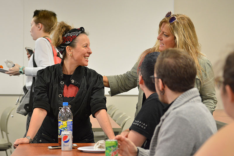 Jonel Langenfeld (right), a theatre department faculty member, greets alumna Tammy Wilkinson (left), class of 1994 and now artistic director for Theatre du Jour