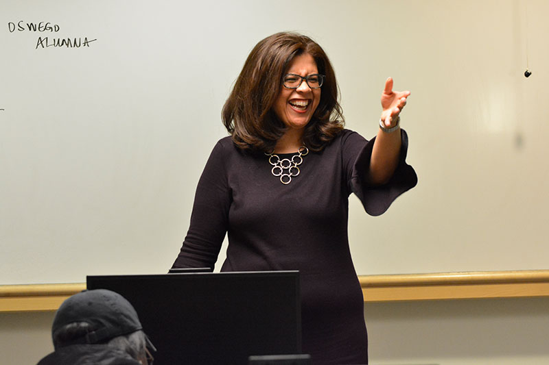 Trudy Perkins gestures while speaking to a class