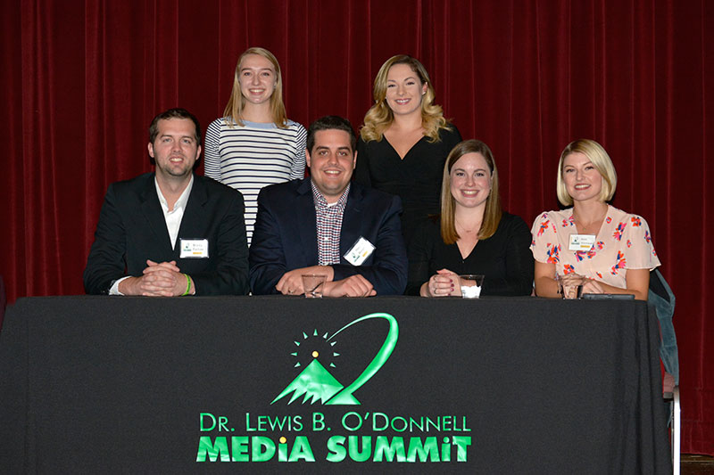 Career Connectors, alumni working in communications, and organizers of the event post after their panel presentation