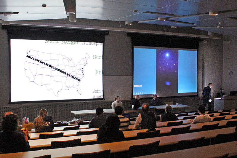 Moderator Scott Roby of the physics department, at the podium, shows the path of the Aug. 21 total eclipse of the sun