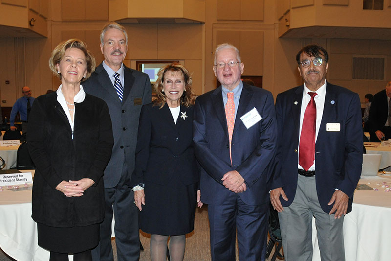 SUNY Oswego administrators and keynote speaker Henry Etzkowitz pause during incubator conference