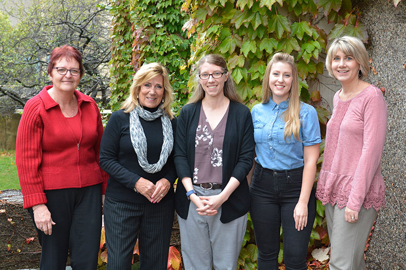 Five staff and faculty members lined up outside Hewitt Hall, three of them SEFA bake-off winners