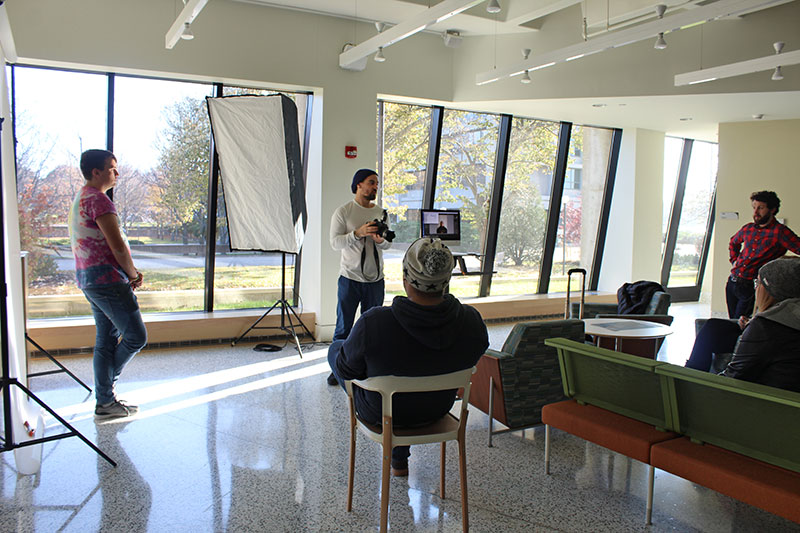 New York City-based photographer Mark Hartman (center) presents to students in Tyler Hall lobby