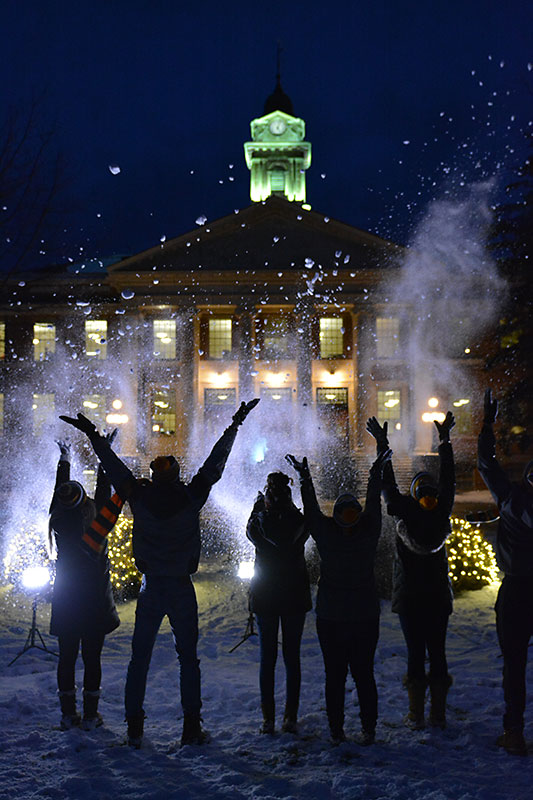 Students having fun in snow in front of Sheldon Hall