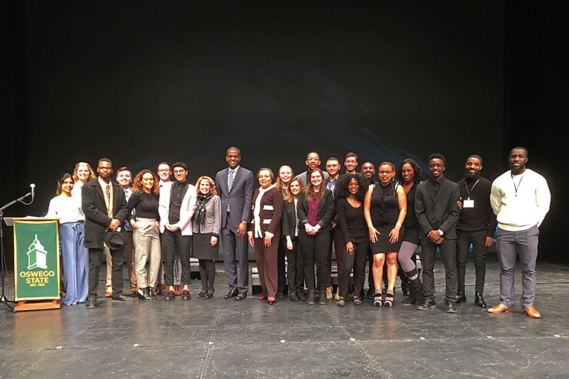 President Deborah F. Stanley, VP Jerald Woolfolk, speaker Bakari Sellers and students gather