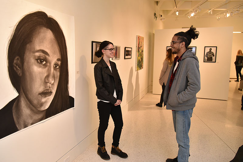 Students view juried student art exhibition