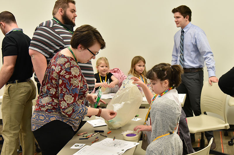 Technology education student Olivia Bauer assists during a STEM 4 Kids activit