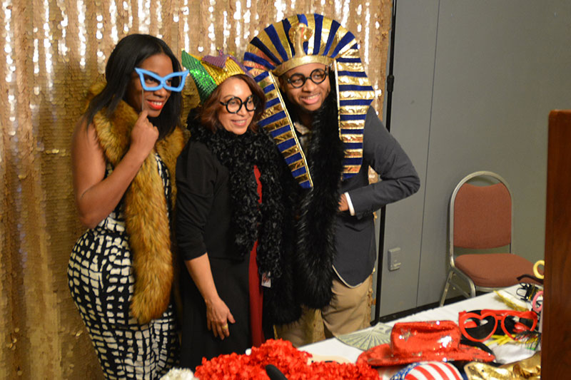 Visitors to Black Student Union 50th anniversary celebration dress up with props and costumes