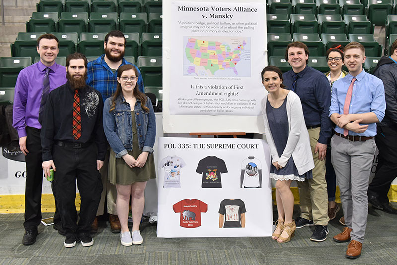 Political science students make poster presentation on free speech and campaigning