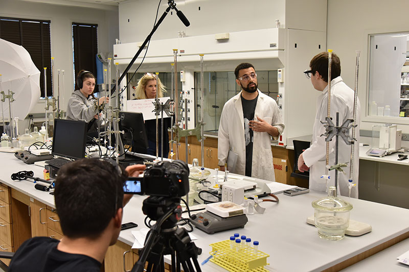 Students work on film about lab safety