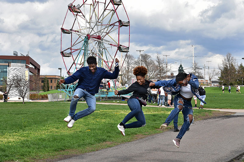 Students celebrate OzFest in front of Ferris wheel