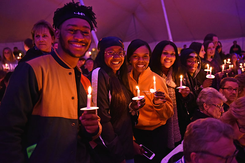 Graduating seniors holding candles