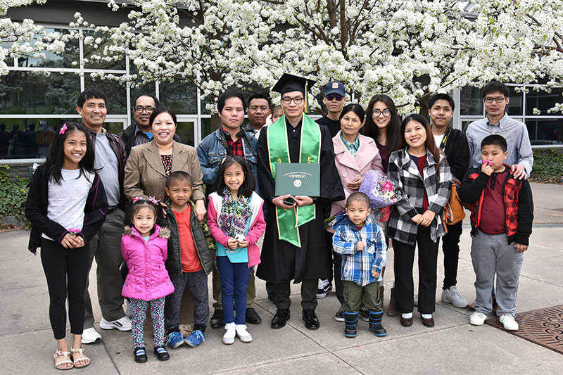 Graduate Joel Kilung and his family from Myanmar gather