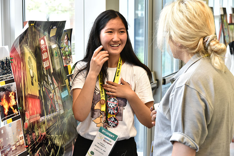 Aidana Obolbekova explains research during GENIUS Olympiad