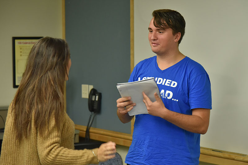 Micah Pasinski talking with another student after study-abroad panel