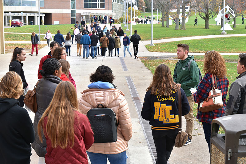 Admissions tour guide Cameron Murray, a sophomore technology education major, speaks with a group of prospective students and their relatives