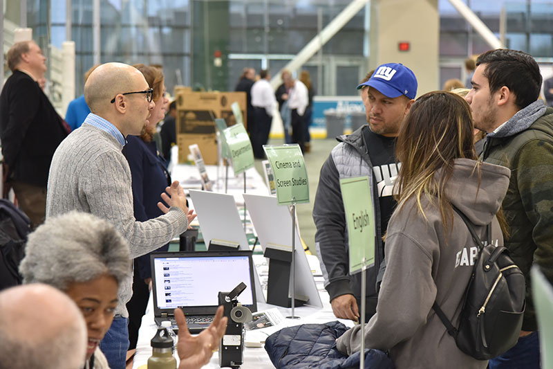 Jake Dodd, a faculty member in the English and creative writing department, talks to a group of visitors Nov. 12 at Veterans Day Open House