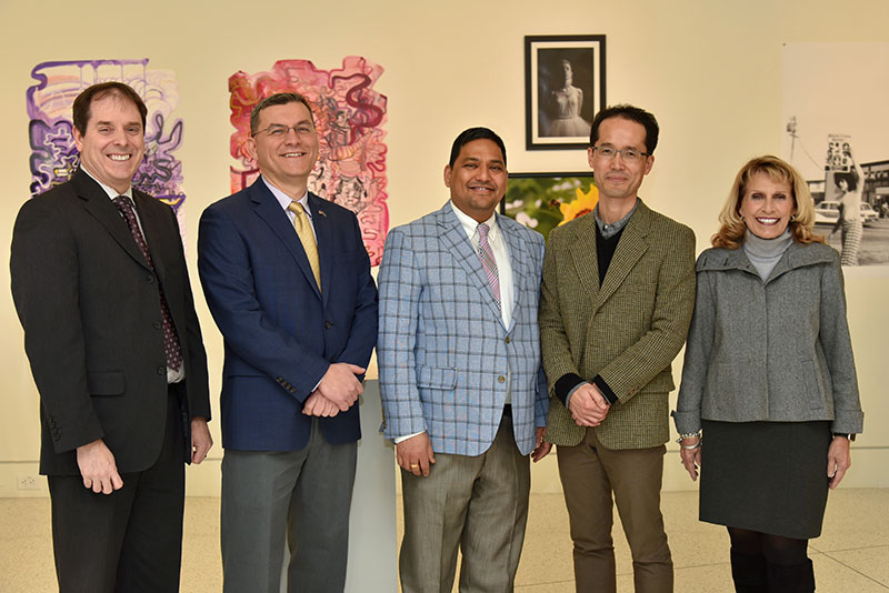 Provost Scott Furlong and college President Deborah F. Stanley flank new full professors Fehmi Damkaci, Arvind Diddi and Taejin Jung