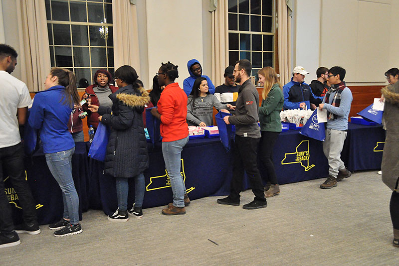 Student volunteers go through the line to assemble comfort kits for survivors of domestic violence