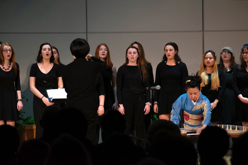 Women's Choir performs as Masayo Ishigure plays a koto