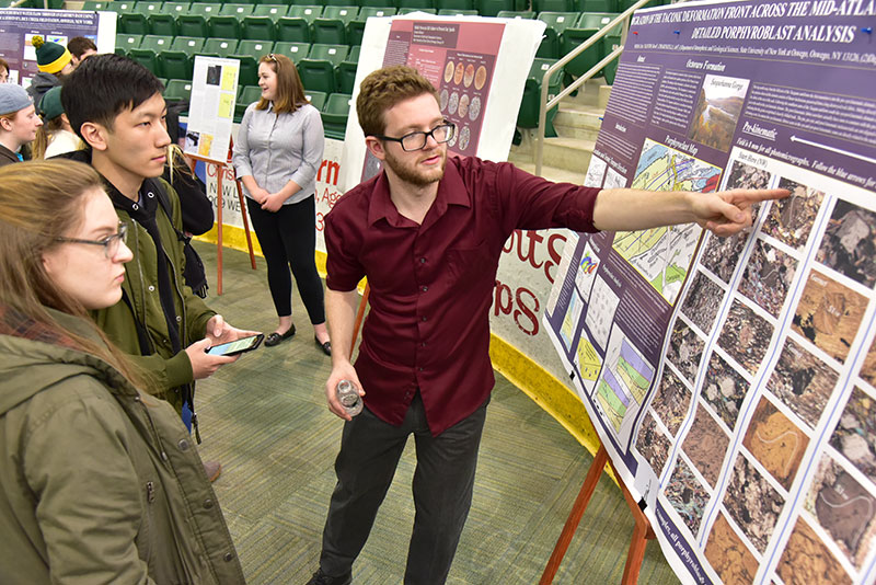 Geology major Christopher Weiman explains his research at Quest's Poster Session