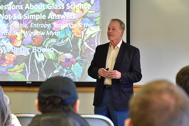 Alumnus Peter Bocko speaks with a class about glass science