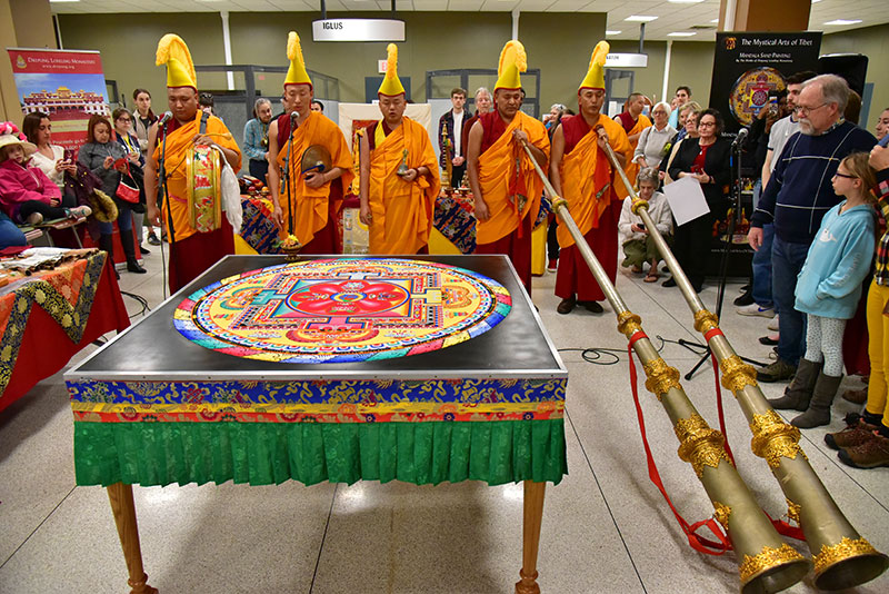 Monks ready their 12-foot horns, a drum, cymbals and a bell as they chant during the closing ceremony of "The Mystical Arts of Tibet"