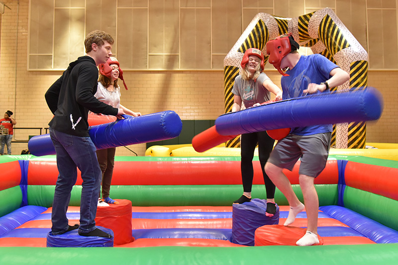 Student participate in an inflatable pugilistic game at OzFest