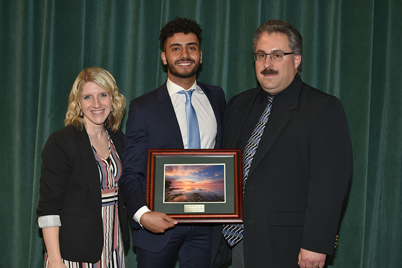 Ahmed Albajari with staff celebrating his selection as 2019 Outstanding Senior