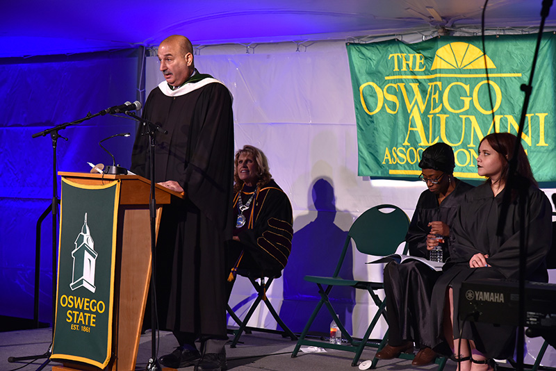 John McLoughlin addresses graduating seniors and a crowd of hundreds of others during the Torchlight Ceremony