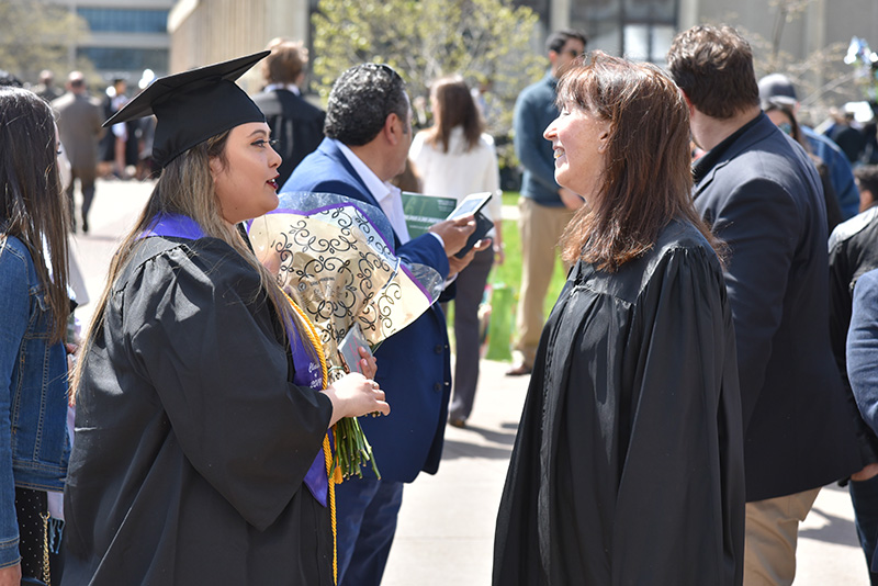 Mary Tone Rodgers (right), Marcia Belmar Willock Professor of Finance, congratulates finance major and economics minor Rita Azzer following Commencement