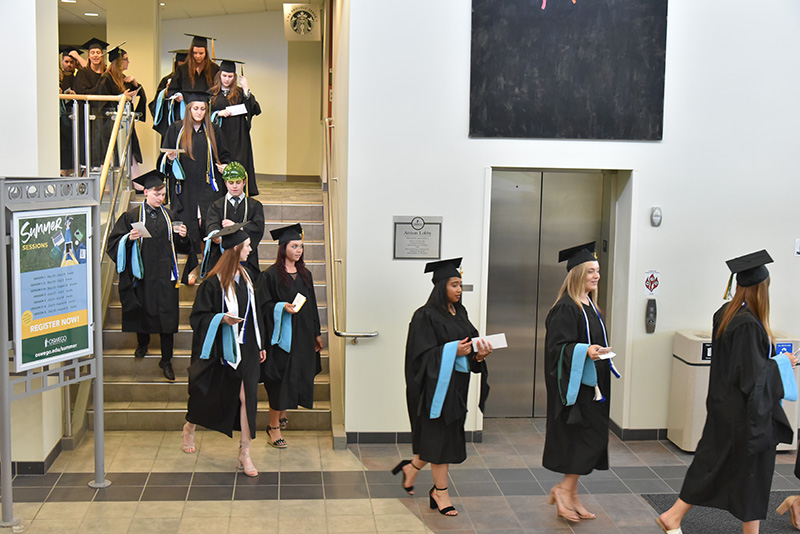 Candidates for graduate degrees and certificates leave the afternoon Division of Graduate Studies