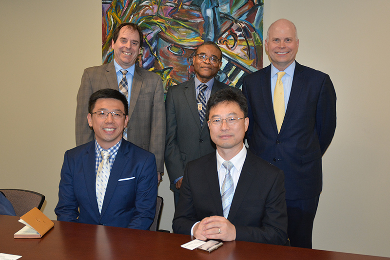 Representatives of China and SUNY Oswego commemorate an upcoming ceremony celebrating a 2009 partnership where SUNY helped Chinese students displaced by a massive earthquake